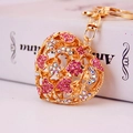 Golden heart-shaped keychain with pink rhinestones and hollow-out metal design - Individual Packaging / Pink