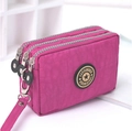 Three-zippered washed denim style clutch in rose red with a wristlet and round logo - Medium / Rose Red