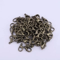 Macro view of vintage bronze zinc alloy lobster clasps for DIY jewelry necklace making - 14mm / Bronze