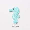 Macro detail of a light blue resin seahorse charm for DIY crafts measuring 20x33mm - Seahorse