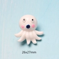Macro shot of white cartoon octopus resin accessory with 26x27mm size marking - Little Octopus