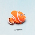 Macro shot of an orange resin clownfish accessory with 22x31mm dimensions marked - Large Clownfish
