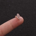 Macro shot of tiny rose gold bow earring with white zircon inlay held between fingers - Rose Gold Butterfly Style (Rose Gold 2#)