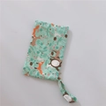 Detail of fabric phone pouch with green forest animal patterns and matching wrist strap - Blue Fox and Bear