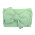 Mint green bubble fabric baby headband featuring a large textured decorative bow - Mint