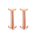 Macro shot of rose gold heart-shaped lip studs with smooth polished metal surfaces - Heart / Rose Gold