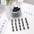Mini black plastic hair claw clips set shown in a clear round storage container - 1.0cm / Black
