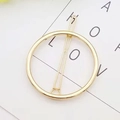 Minimalist geometric round hair clip in golden finish on a clean white background - Round
