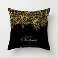 Detail eines schwarzen Weihnachtskissenbezugs mit goldenen Schneeflocken und Schriftzug - Schwarz Gold Schneeflocken-Array