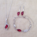 Detail view of silver jewelry set featuring red oval gemstones and shimmering rhinestones - Silver Bright Red
