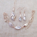 Overhead view of rose gold angel crystal jewelry set including necklace, bracelet and earrings - Gold White