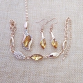 Rose gold jewelry set with yellow teardrop crystals and small diamonds on beige linen - Gold Yellow