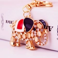 Golden elephant keychain with opal stone and rhinestones, perfect for handbags and car keys - White