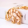 Golden elephant keychain with cat-eye stone, white crystals, and a green rhinestone eye - White Elephant 633