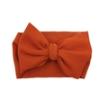 Rust red infant headband with large bow made of textured waffle knit fabric - Rust red