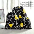 Three sizes of geometric drawstring bags with deer head prints in black, white, and yellow - Heart Deer Black Triangle