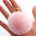 Pink 7cm faux rabbit fur pom pom keychain with gold ring held in hand for scale - 7cm Pom-pom / Light Pink