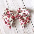 Detailed close-up of a wide fabric headband featuring a 3D large watermelon print bow - Watermelon