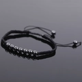 Macro shot of hematite beads on a black braided cord bracelet with mirror reflection - Black Style 2