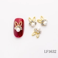 3D gold bunny nail charm with white pearl and crystals on a dark red nail, model LF1632 - Gold Rabbit Ear Green Zircon Pearl Style (LF1632)