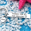 Engraved stainless steel keychain with humorous quote on blue sand and white pebbles - 1032.2 Mirror Style