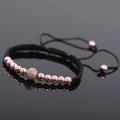 Macro shot of rose gold beads and zircon ball on an adjustable black braided bracelet - Rose Gold Style 1