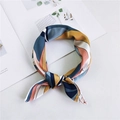 Elegant multi-color patterned silk scarf tied in a knot on a minimalist desk surface - Camo Navy Pink
