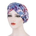 Detailed close-up of floral print turban with decorative braided trim on a model - Lake Blue