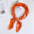 Orange paisley silk scarf with polka dot border styled on a magazine background - 70cm / Orange