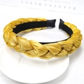 Elegant yellow braided headband with satin luster finish on professional background - Yellow