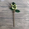 Artificial green berry stem with detailed leaves on dark wood texture background - Small Leaf Green Berry