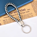 Portachiavi in pelle intrecciata a scacchi bianchi e neri con anello in metallo lucido - Patchwork Nero e Bianco