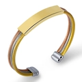 Detailed shot of triple-tone twisted steel cable bracelet in gold silver and rose gold - Tricolor (Gold Silver Rose Gold)