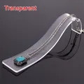 Detail of transparent acrylic S-curve necklace display stand with turquoise pendant - Clear