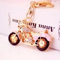 Golden motorcycle keychain with pink crystals and shiny metal finish on bike model - Pink Motorcycle