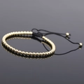 Close-up of adjustable black braided cord bracelet with gold hematite beads and polished finish - Gold Style 3