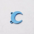Macro detail of a blue crescent moon pendant in titanium steel with dual connector holes - Blue