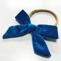 Detail of soft blue velvet bow baby headband with elastic nylon band on white background - Sky Blue