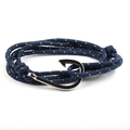 Navy blue woven nautical bracelet with polished silver anchor hook clasp on white background - Dark Blue Polka Dot