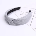 Close-up of light grey knitted cotton headband with knot detail and ribbed fabric texture - Light Gray