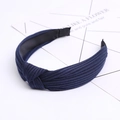 Close-up of navy blue ribbed fabric headband with a stylish knotted design - Navy Blue