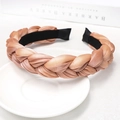 Detail of champagne braided headband with silk texture on white tray with book - Pink