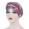 Close-up of the braided twist detail on the floral print turban cap with vibrant patterns - Red & Green