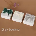 Elegant square jewelry boxes with satin bows in dark green, beige, and grey colors - Gray Bow Decorated Box