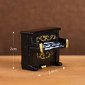 Miniature black resin upright piano model with gold accents and size markings - Piano