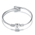 Close-up of silver twisted cable bracelet with a heart charm engraved with letter V - Letter V / Steel