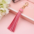 Elegant pink faux leather tassel keychain with a gold lobster clasp for bags and accessories - Pink