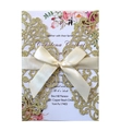 Detail of laser-cut gold glitter wedding invitation with ivory ribbon and floral card - Gold