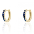 Macro view of gold huggie hoop earrings with rows of small inlaid blue zircons - Gold Plated + Blue Zirconia