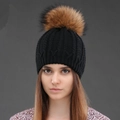 Winter black cable knit beanie for women featuring a fluffy brown faux fur pom pom decoration - Black + Natural Pom Pom